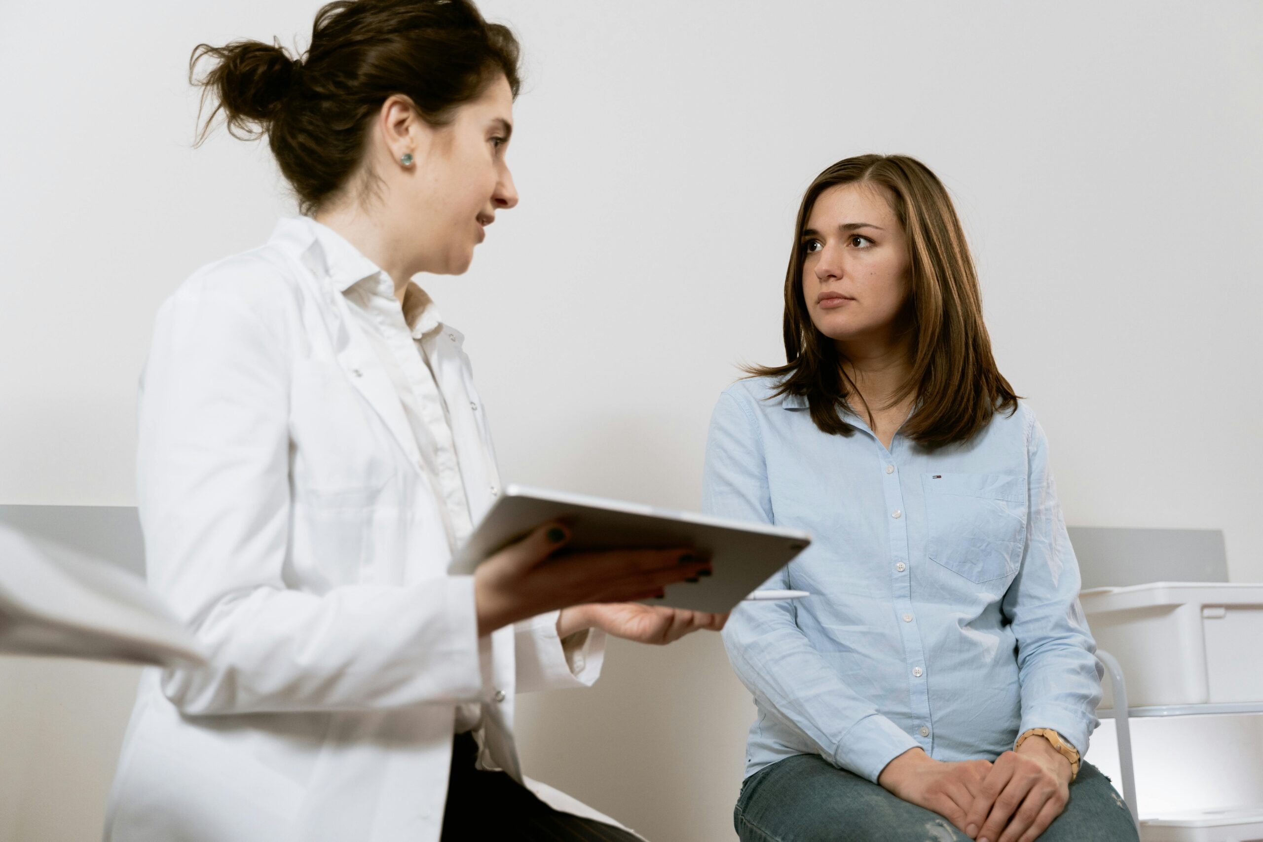 medical professional interviews a woman before a gynecology procedure